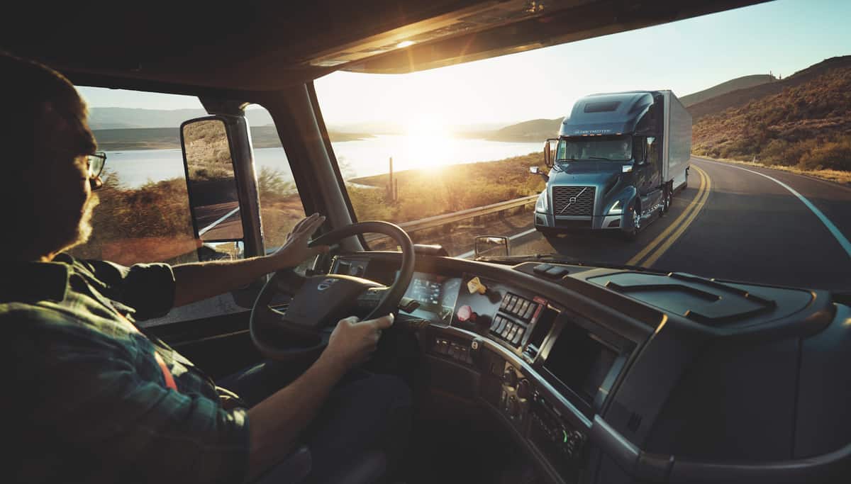 Driver in truck cab passing oncoming semi